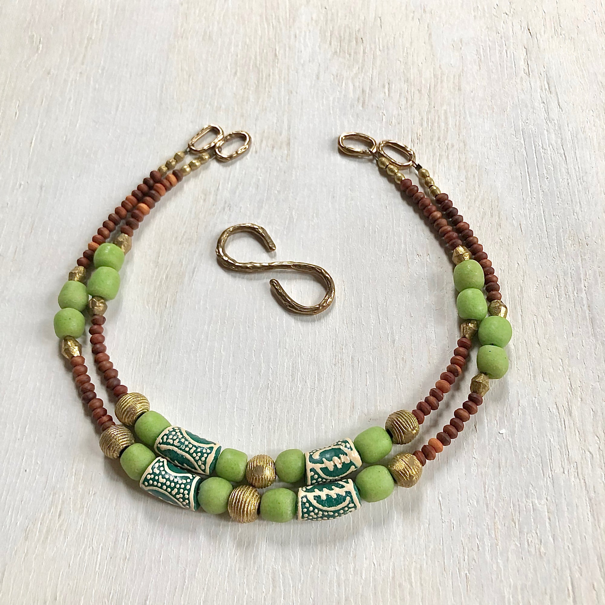 Hand painted green Adinkra African beads with vintage olive wood pendant long necklace. Cristina Tamames Jewelry Designer