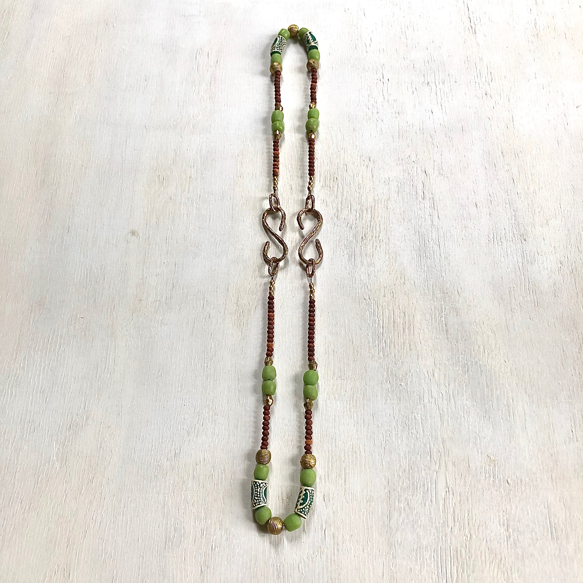 Hand painted green Adinkra African beads with vintage olive wood pendant long necklace. Cristina Tamames Jewelry Designer