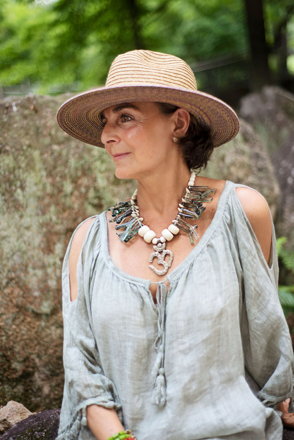 Model wearing a green coral shapes in resin with an Om center piece unique necklace. Cristina Tamames Jewelry Designer