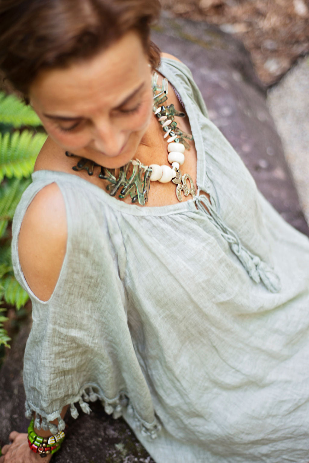 Modeling a green coral shapes in resin with an Om center piece unique necklace. Cristina Tamames Jewelry Designer