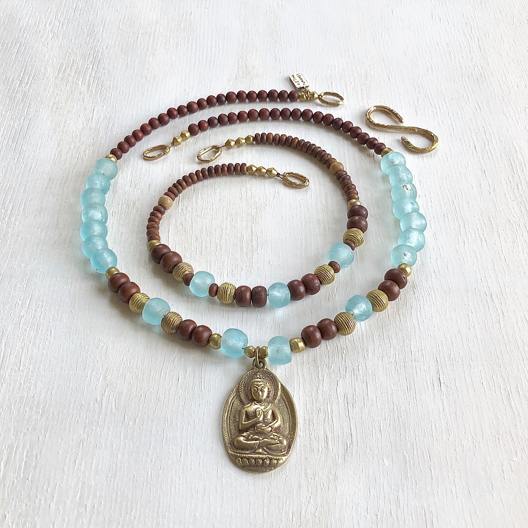 African recycled bottle beads brass Buddha double necklace. Cristina Tamames Jewelry Designer