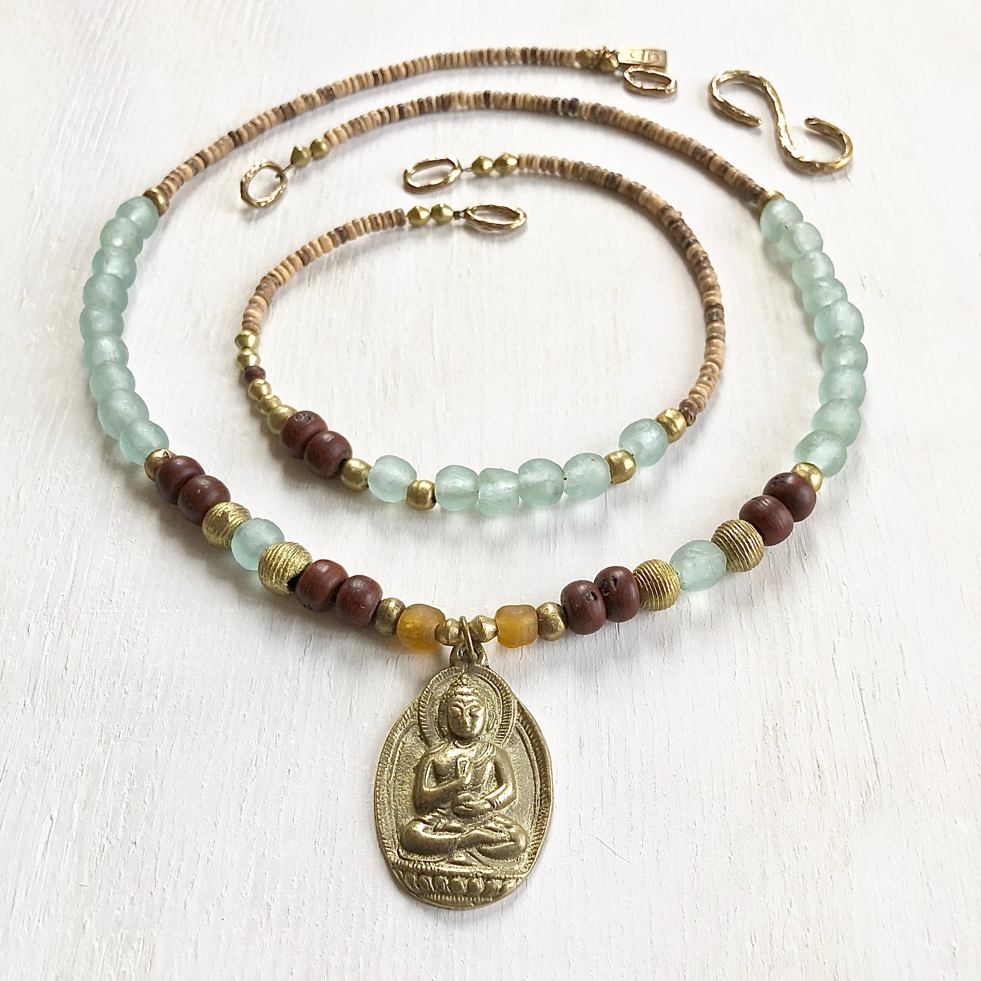 African recycled bottle beads brass Buddha double necklace. Cristina Tamames Jewelry Designer