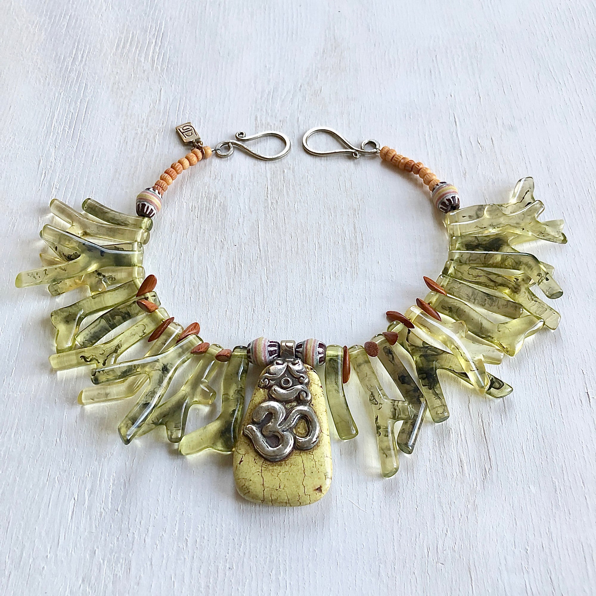 Green shapes of resin coral necklace with  Nepalese Om yellow turquoise pendant . Cristina Tamames Jewelry Designer