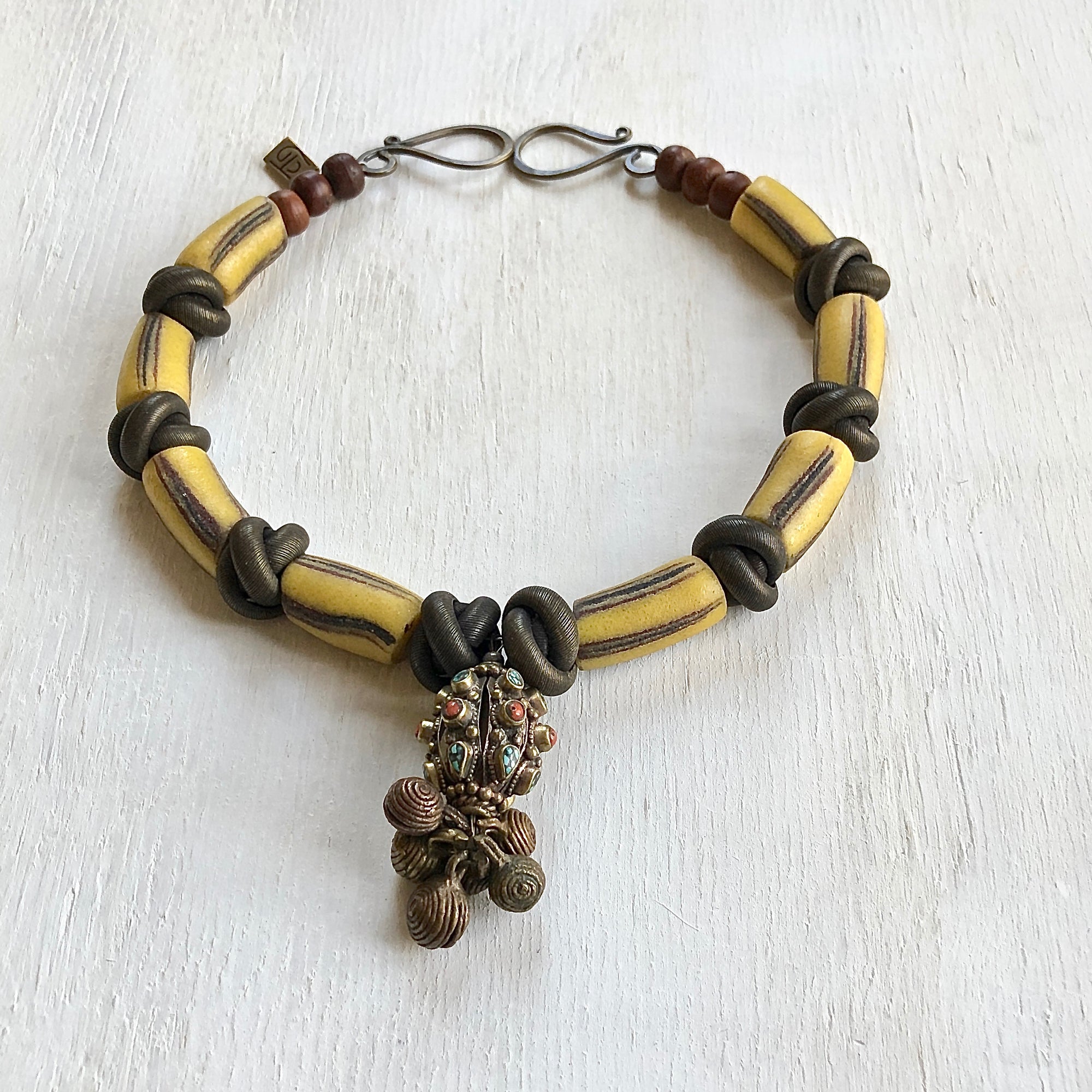 Vintage Nepalese bells center piece African trade beads necklace. Cristina Tamames Jewelry Designer