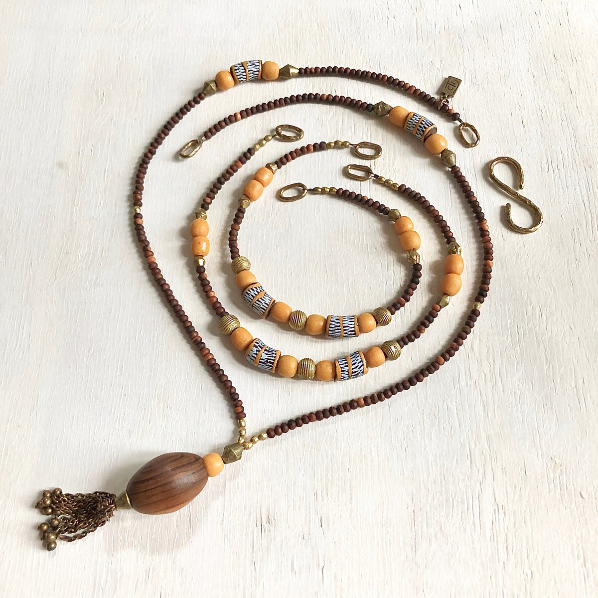 Hand painted brown yellow Adinkra African beads with vintage olive wood pendant long necklace. Cristina Tamames Jewelry Designer