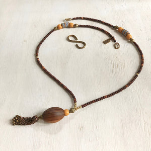 Hand painted brown yellow Adinkra African beads with vintage olive wood pendant long necklace. Cristina Tamames Jewelry Designer