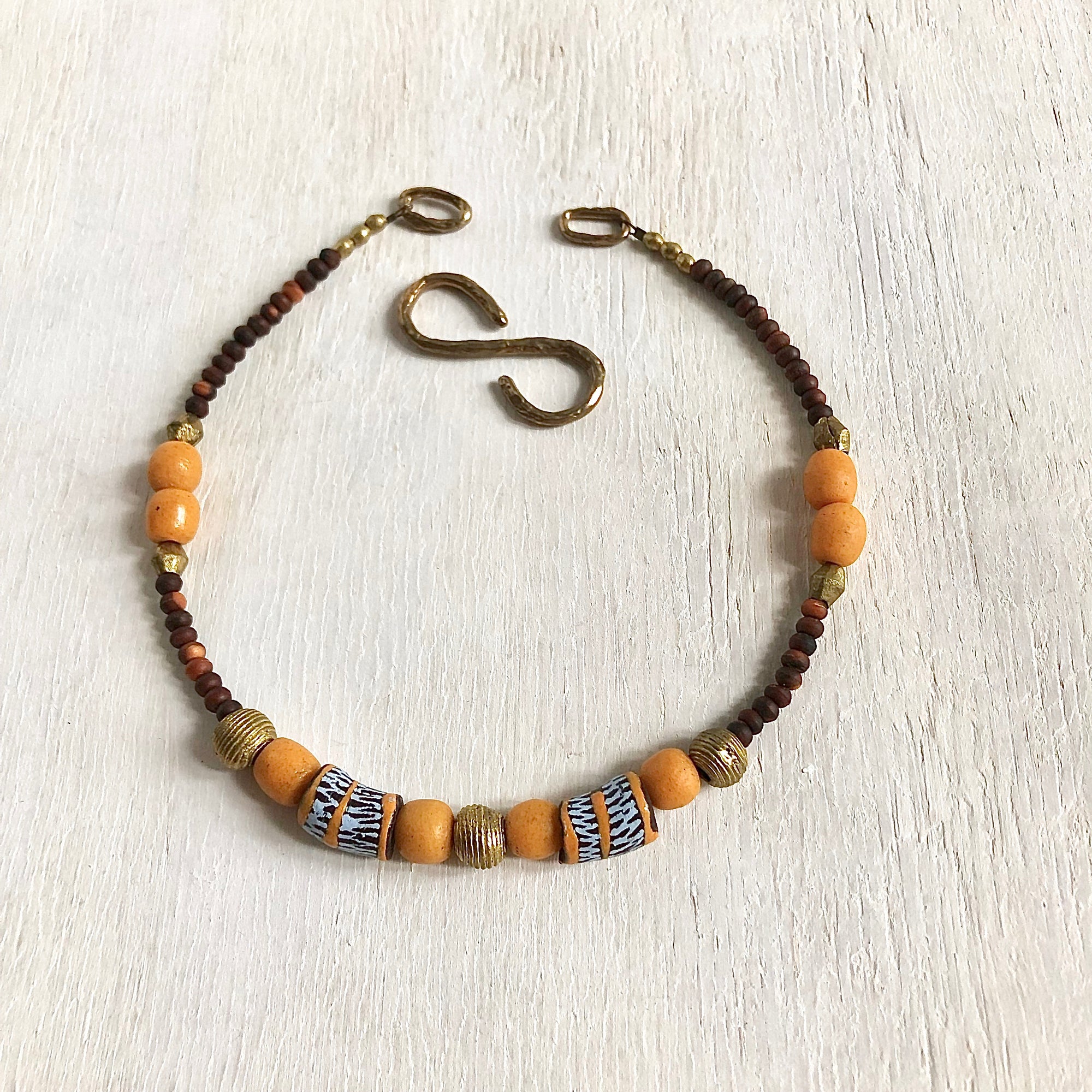 Hand painted brown yellow Adinkra African beads with vintage olive wood pendant long necklace. Cristina Tamames Jewelry Designer