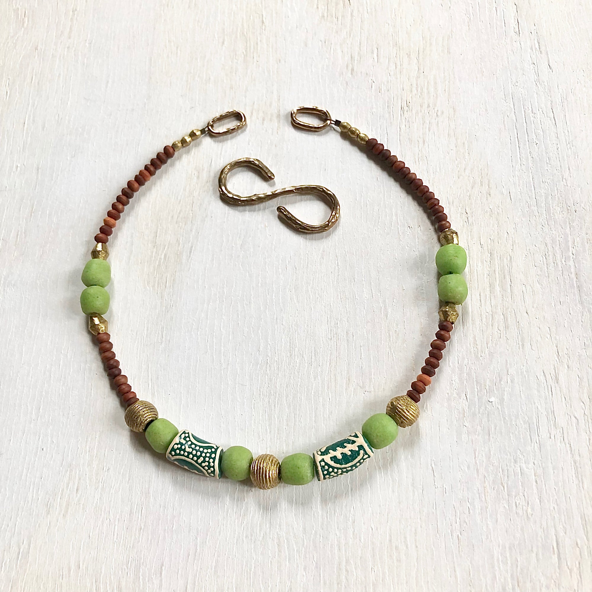 Hand painted green Adinkra African beads with vintage olive wood pendant long necklace. Cristina Tamames Jewelry Designer