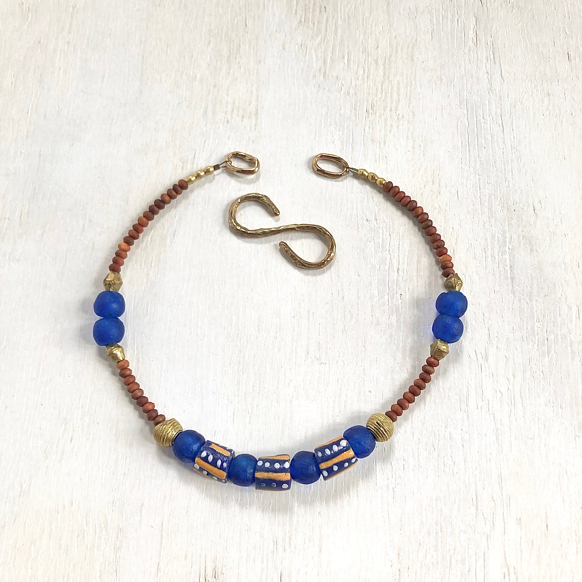 Hand painted blue yellow African beads with vintage olive wood pendant long necklace. Cristina Tamames Jewelry Designer