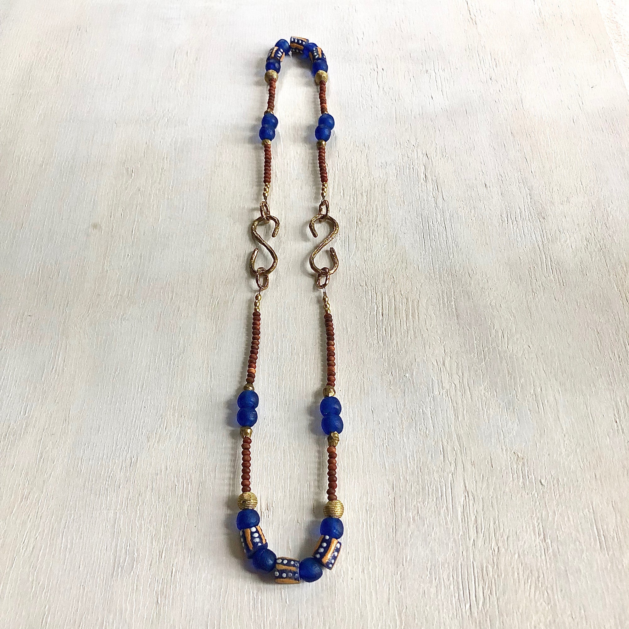 Hand painted blue yellow African beads with vintage olive wood pendant long necklace. Cristina Tamames Jewelry Designer