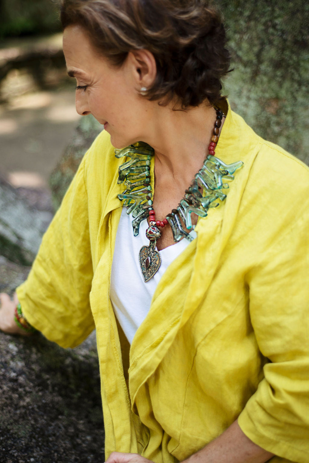 Model wearing a one of a kind necklace made out of  a variety of greens, in the shapes of beautiful corals from the ocean. Light and easy to wear. Cristina Tamames Jewelry Designer 