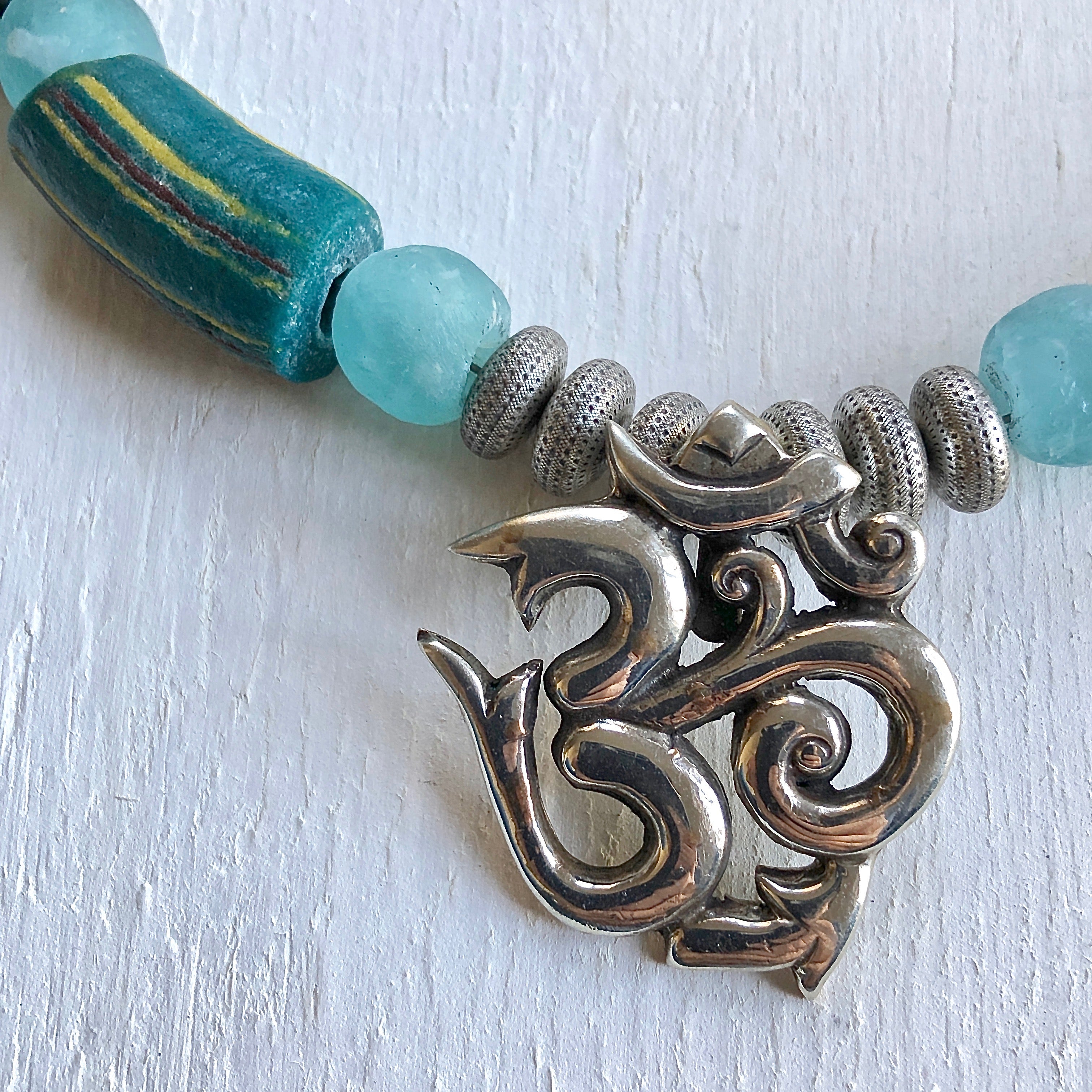Nepalese Om pendant African beads necklace. Cristina Tamames Jewelry Designer