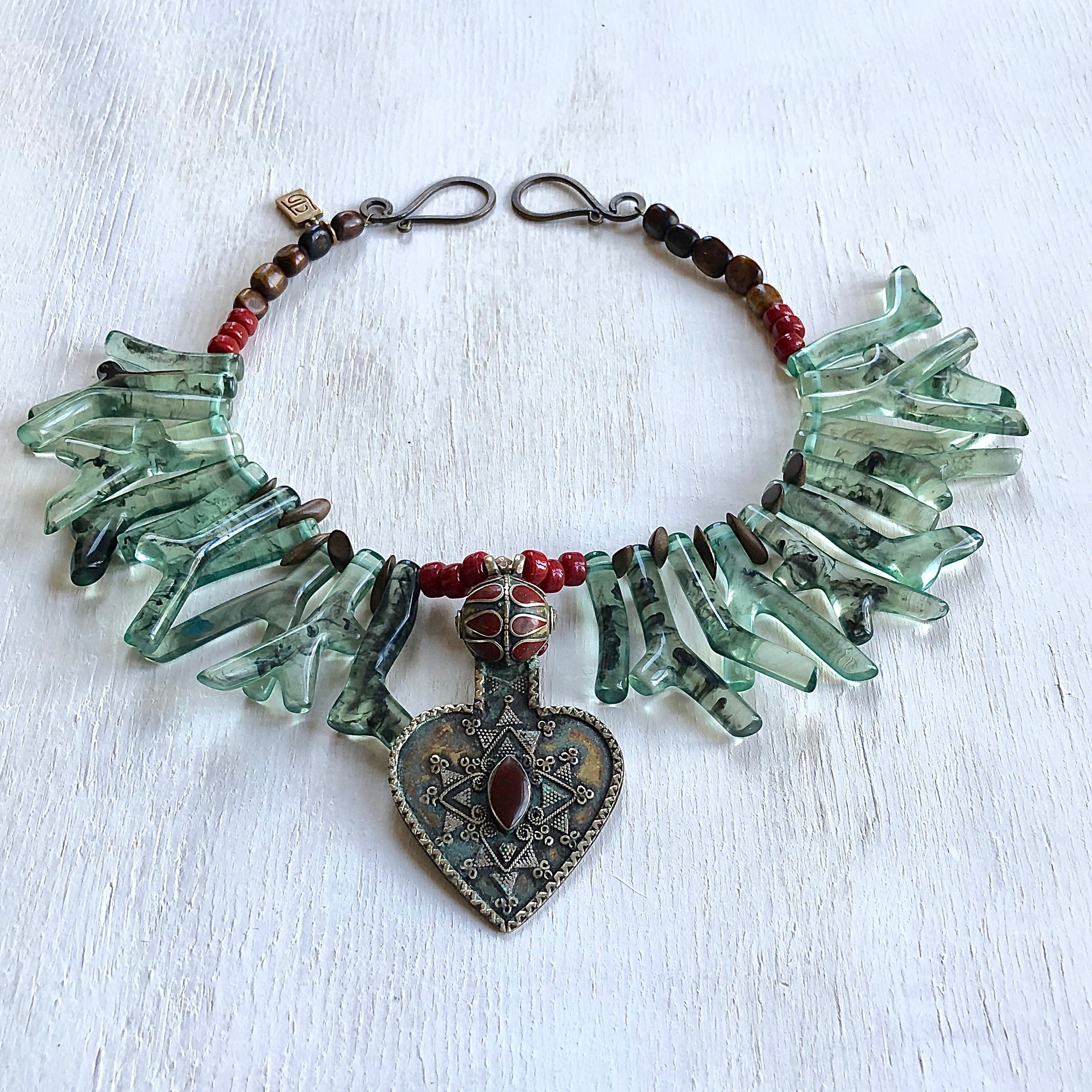 Green shapes of coral made out of resin for this one of a kind  tribal necklace. Cristina Tamames Jewelry Designer