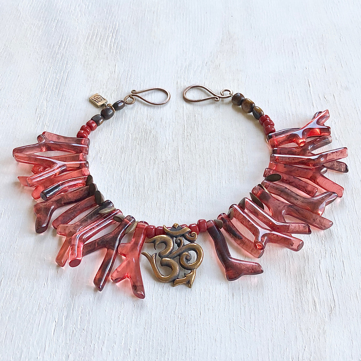 Coral red shapes Om necklace. Cristina Tamames Jewelry Designer