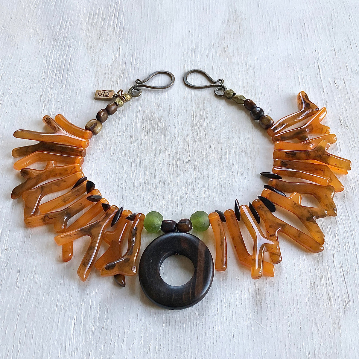Coral orange shapes with ebony center piece necklace. Cristina Tamames Jewelry Designer