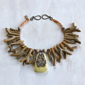 Necklace in earthy tones coral shapes of resin with a Nepalese yellow turquoise pendant. Cristina Tamames Jewelry Designer
