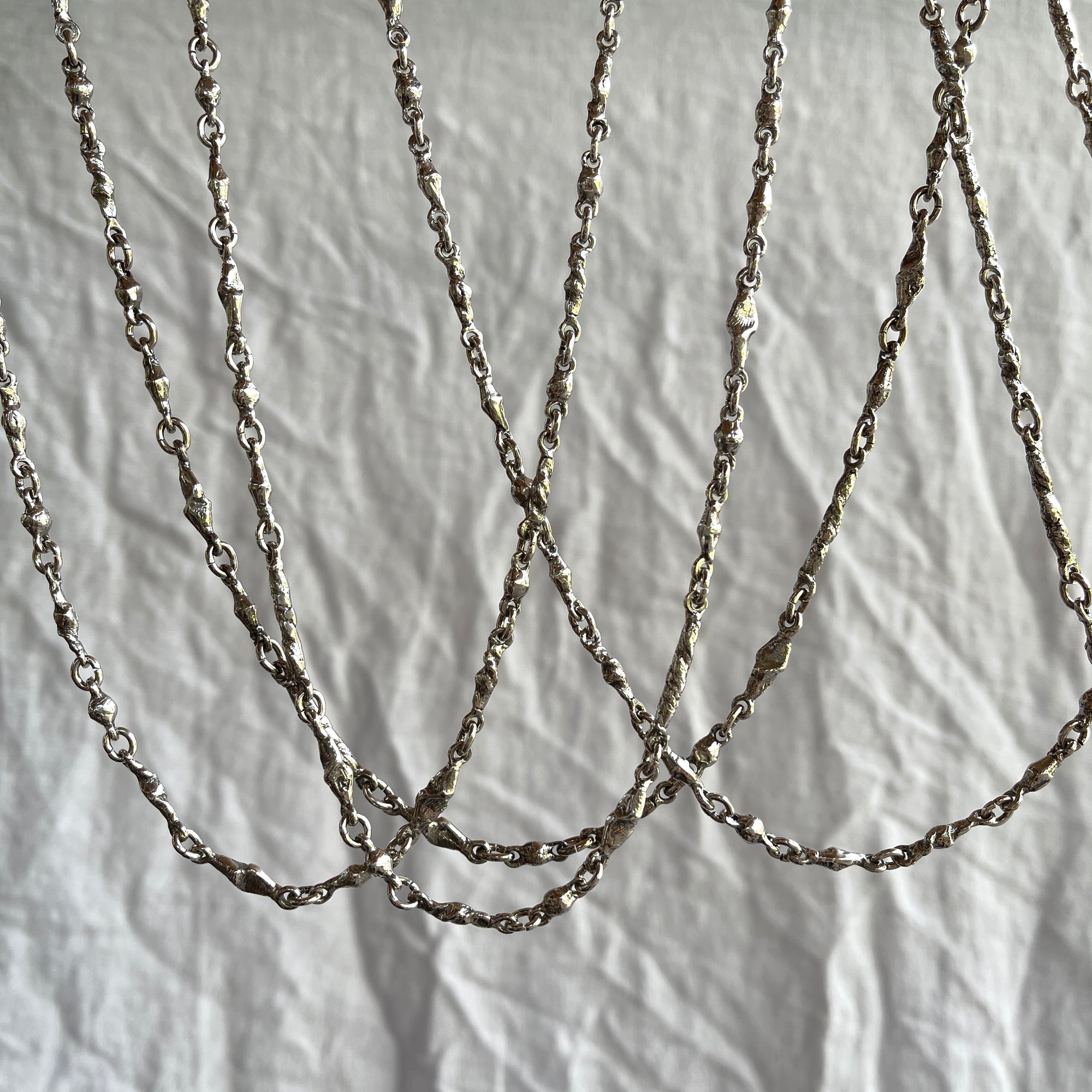 Designer sculptural hand made silver chains. Cristina Tamames Jewelry Designer