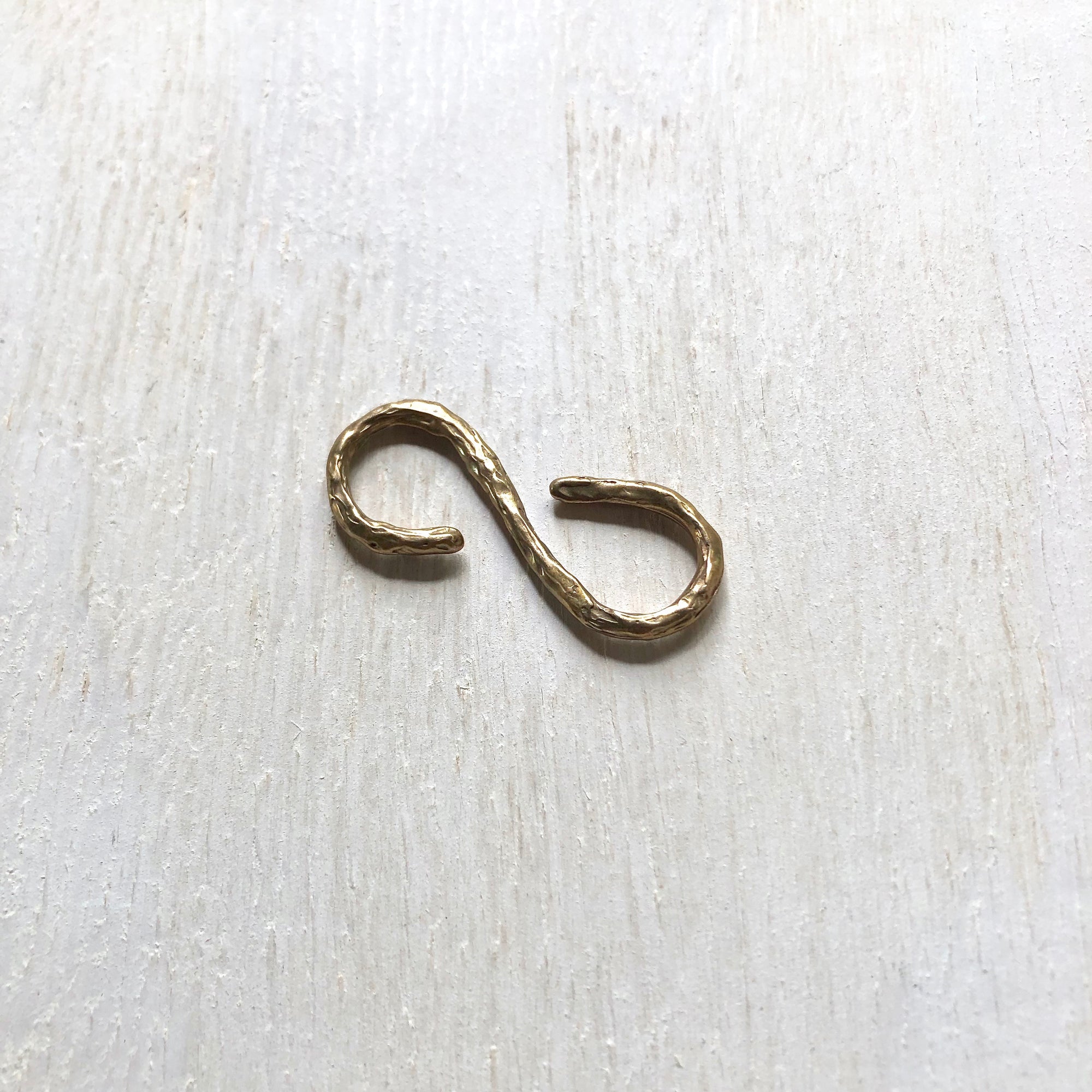 Bronze infinity toggle. Cristina Tamames Jewelry Designer